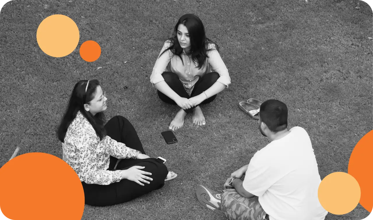 Three people sitting together and talking