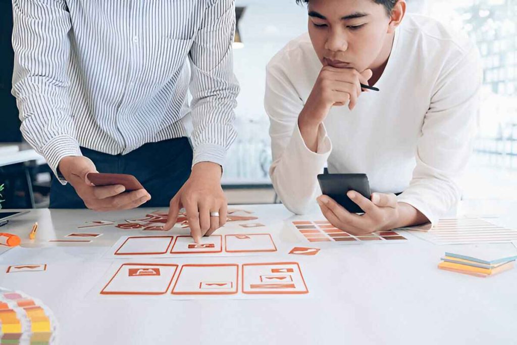 two young man are working on UX design